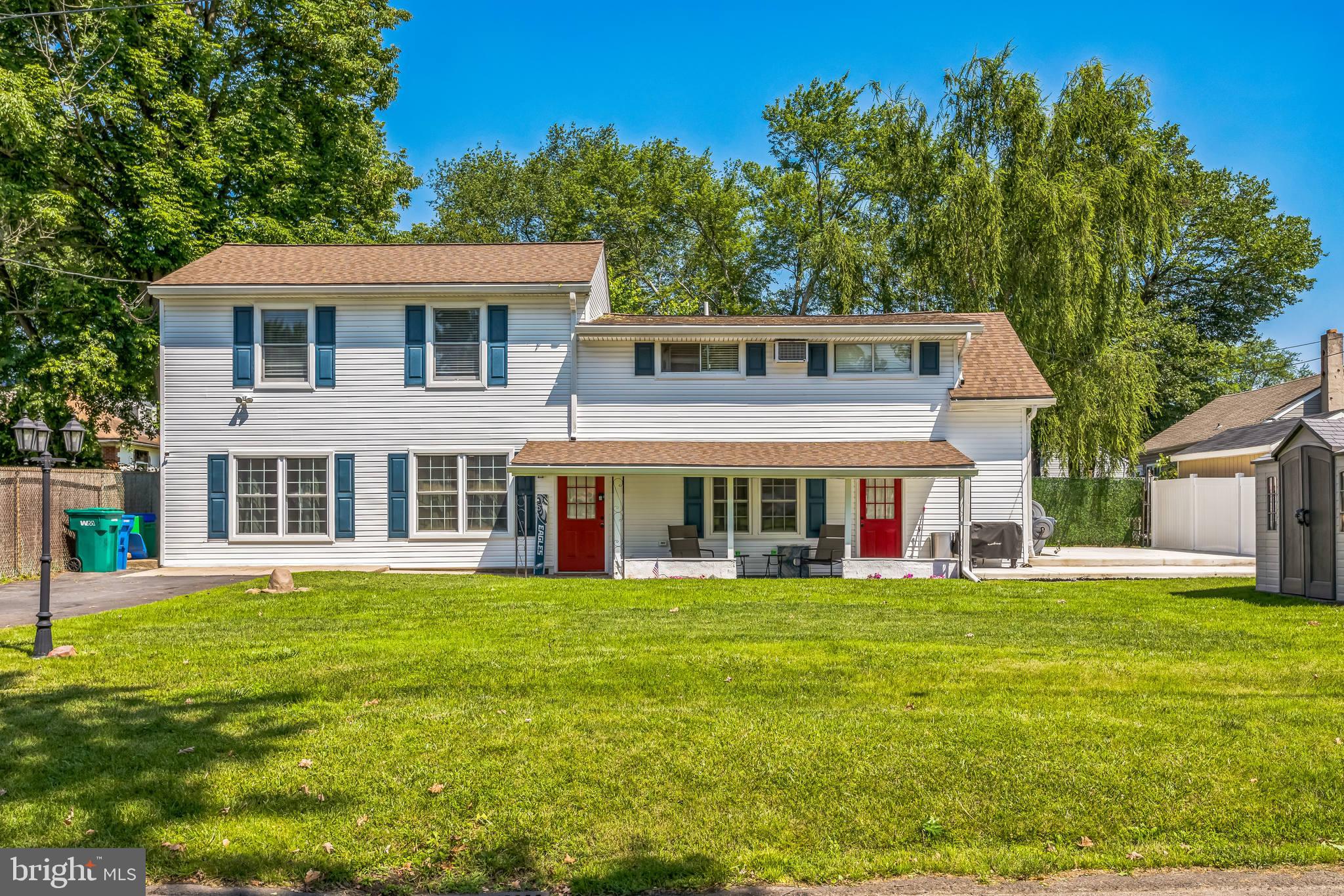 414 Delaware Avenue Croydon, PA 19021 - Photo 34 of 34 a view of a white house with a big yard and potted plants and large trees