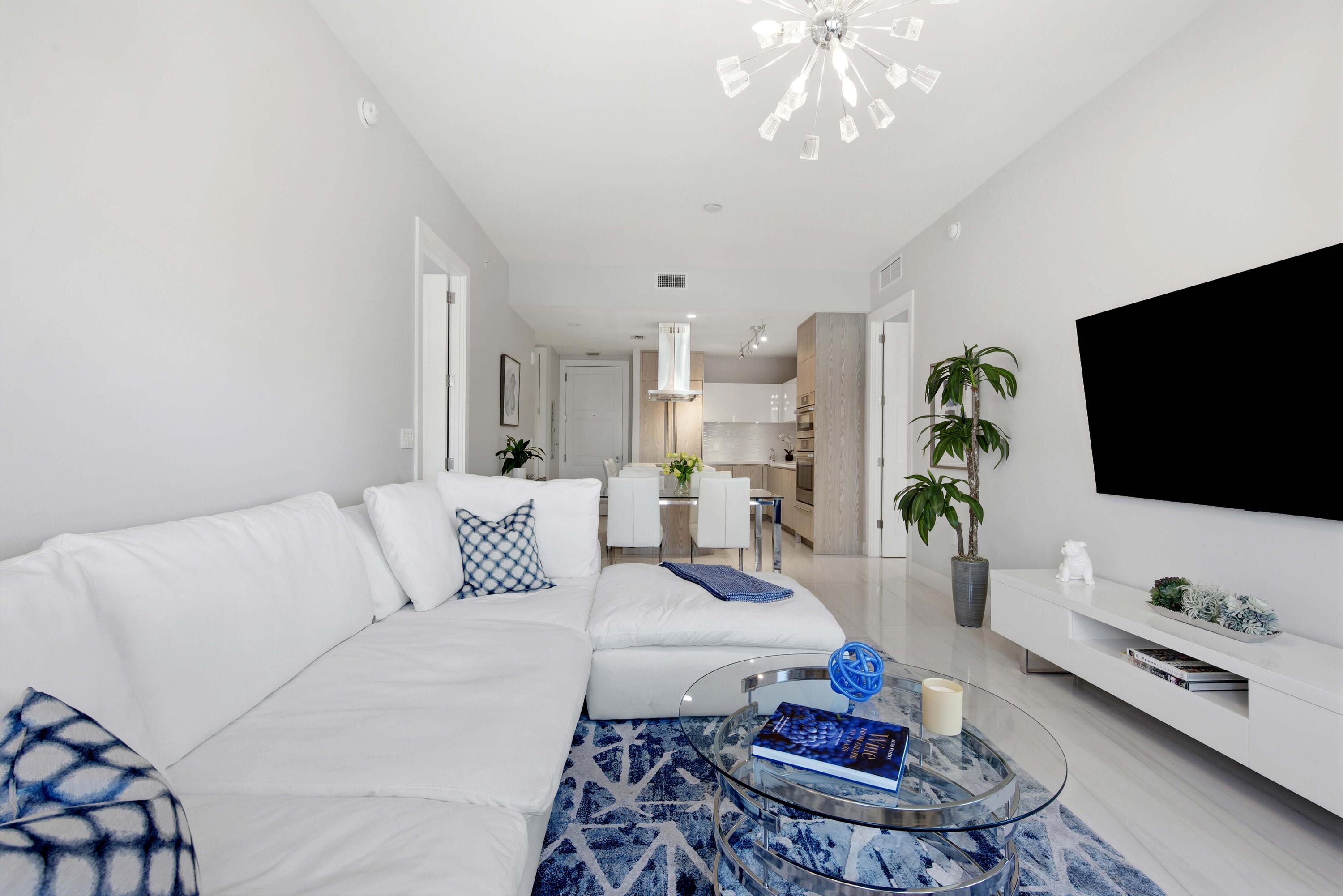 155 East Boca Raton Road, Unit 313 Boca Raton, FL 33432 - Photo 22 of 72 a living room with furniture and a flat screen tv