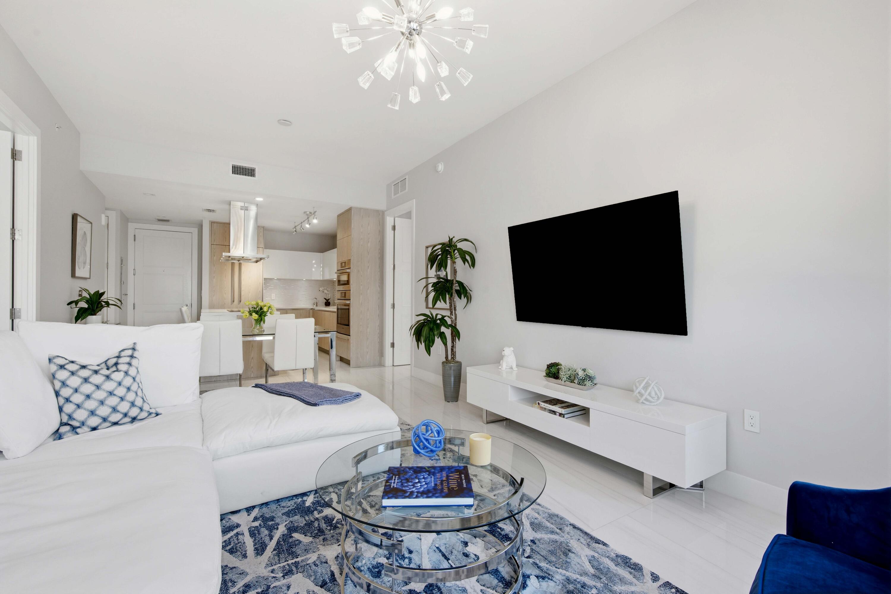 155 East Boca Raton Road, Unit 313 Boca Raton, FL 33432 - Photo 23 of 72 a living room with furniture and a flat screen tv