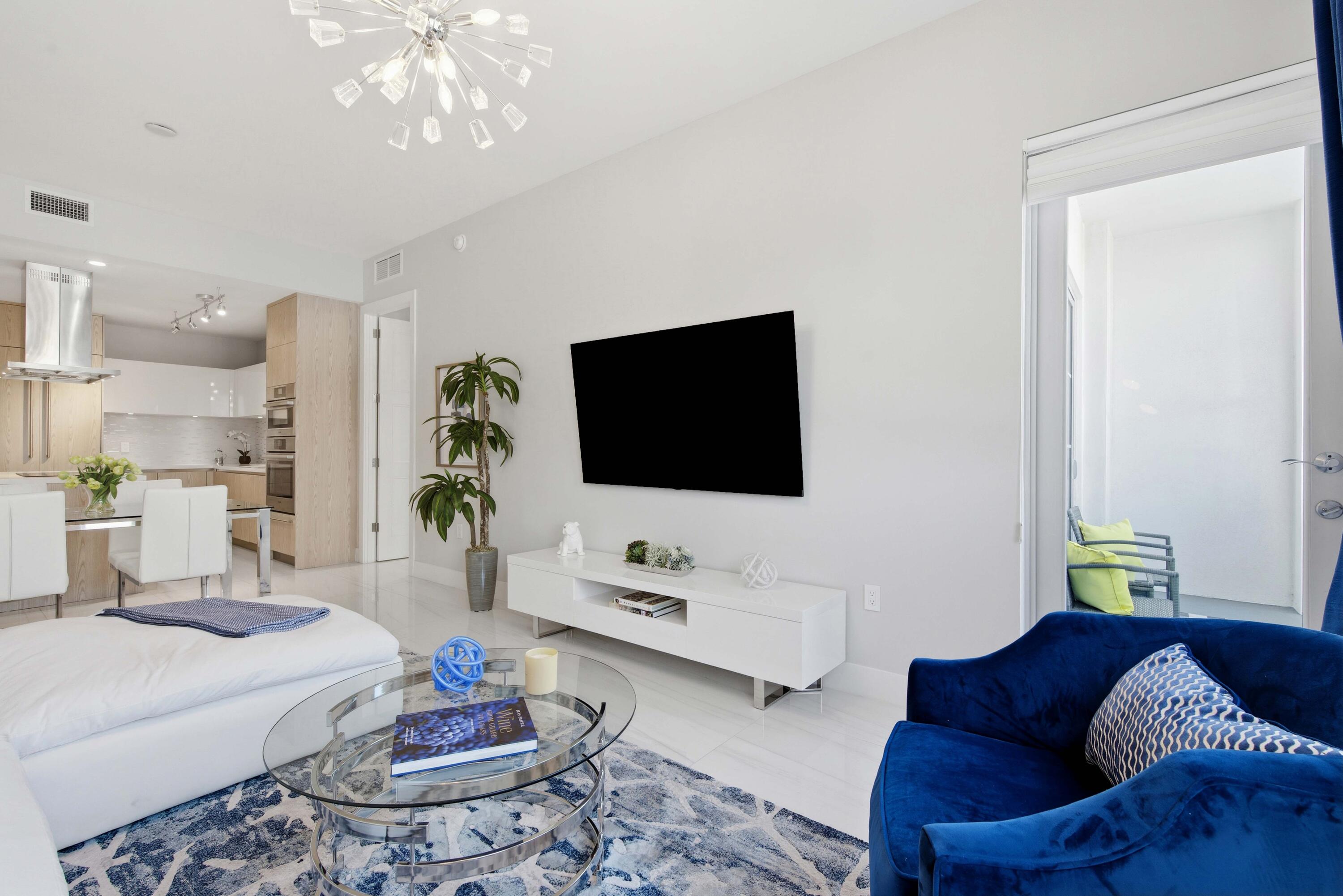 155 East Boca Raton Road, Unit 313 Boca Raton, FL 33432 - Photo 24 of 72 a living room with furniture and a flat screen tv