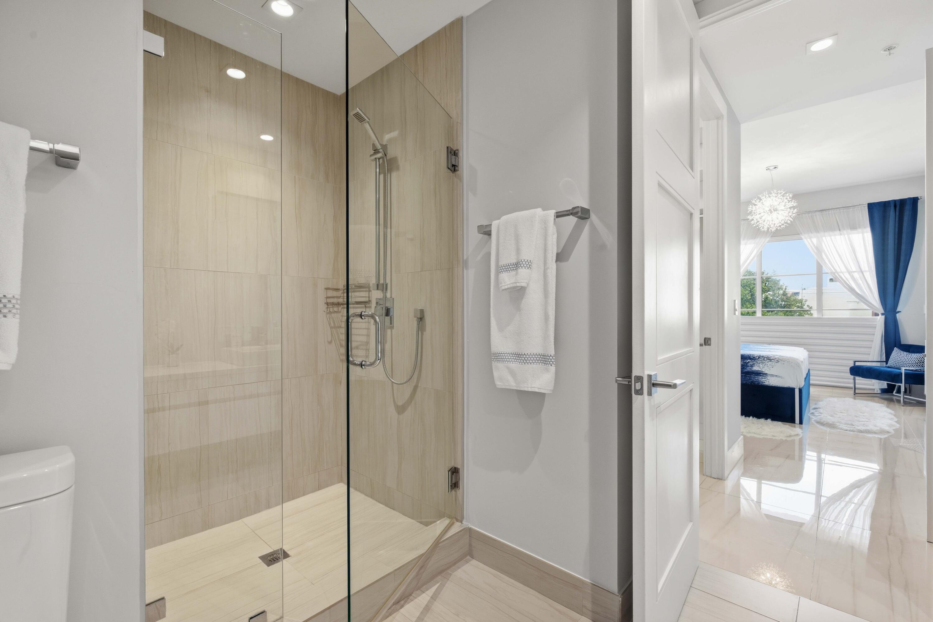 155 East Boca Raton Road, Unit 313 Boca Raton, FL 33432 - Photo 36 of 72 a bathroom with a shower and a glass door