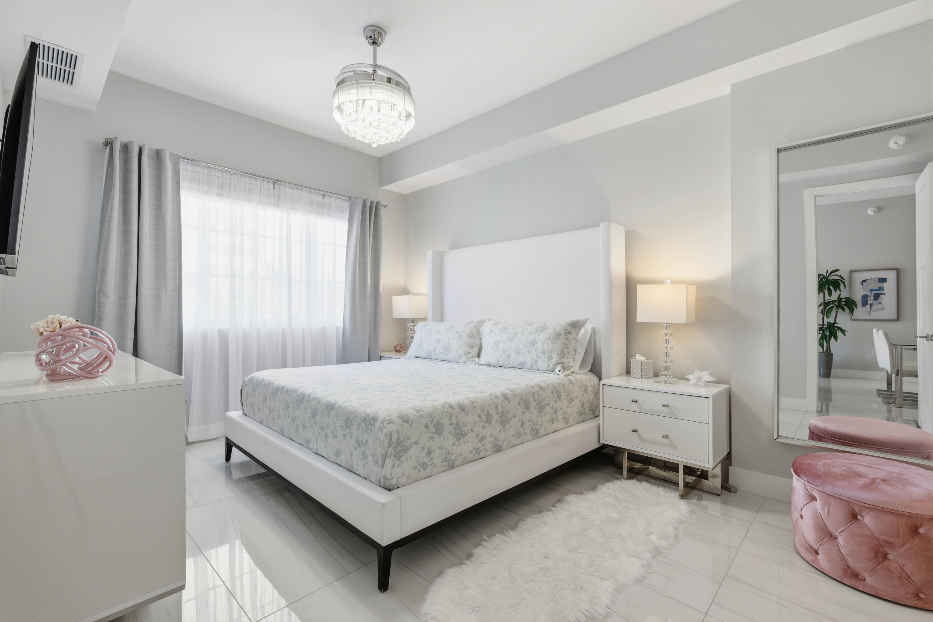 155 East Boca Raton Road, Unit 313 Boca Raton, FL 33432 - Photo 37 of 72 a bedroom with a bed and a chandelier