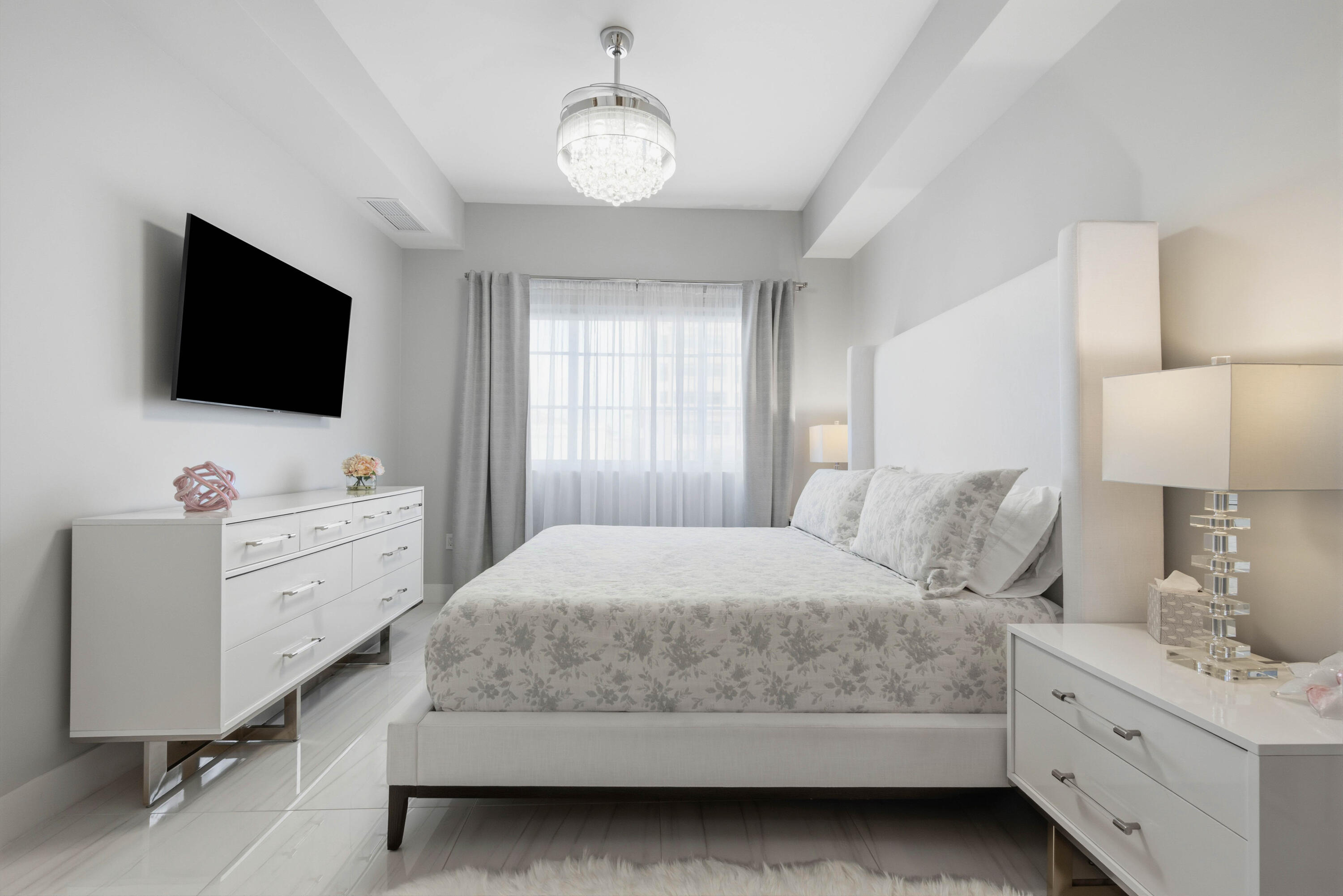 155 East Boca Raton Road, Unit 313 Boca Raton, FL 33432 - Photo 38 of 72 a bedroom with a bed and a flat screen tv