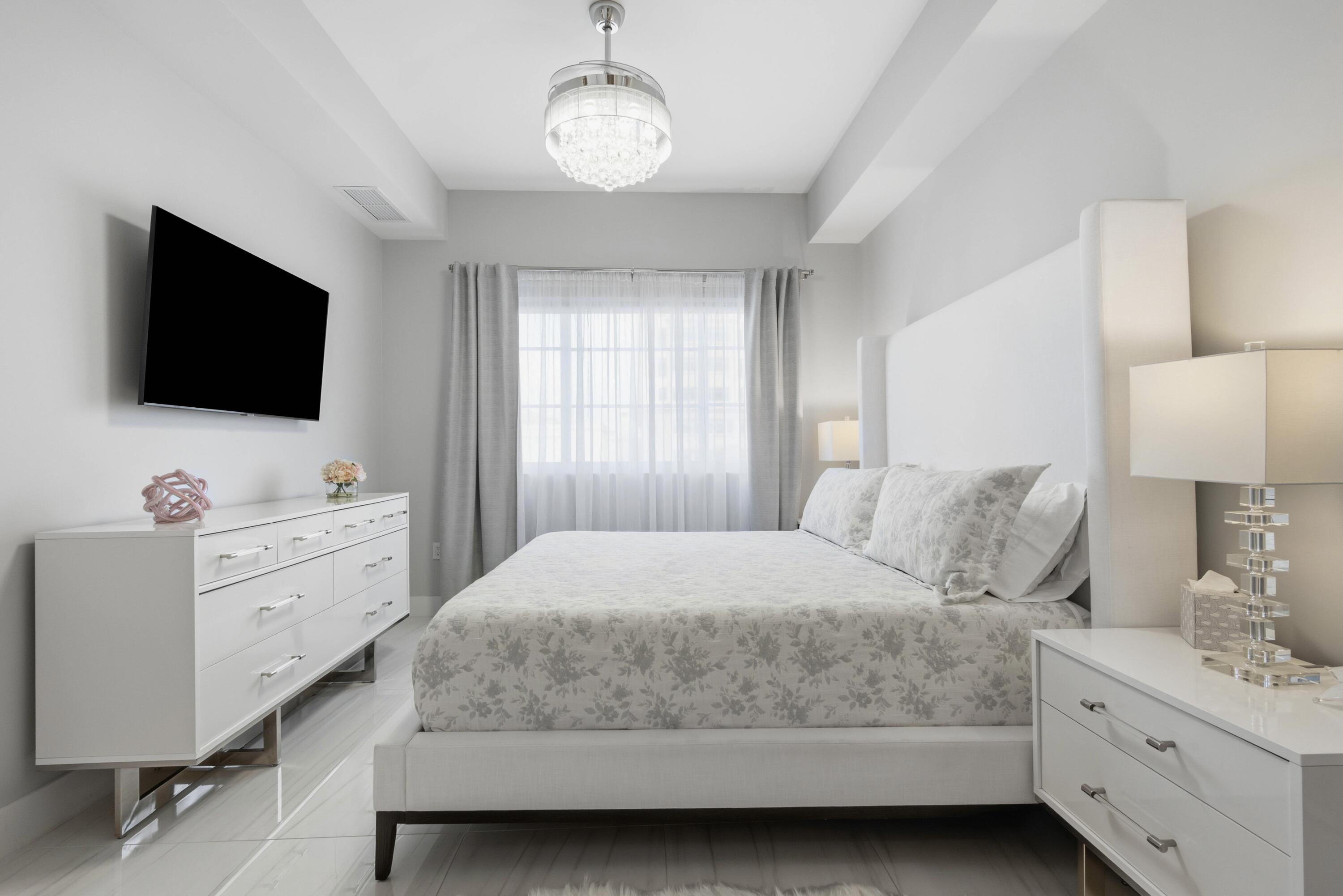 155 East Boca Raton Road, Unit 313 Boca Raton, FL 33432 - Photo 39 of 72 a bedroom with a large bed and a flat screen tv