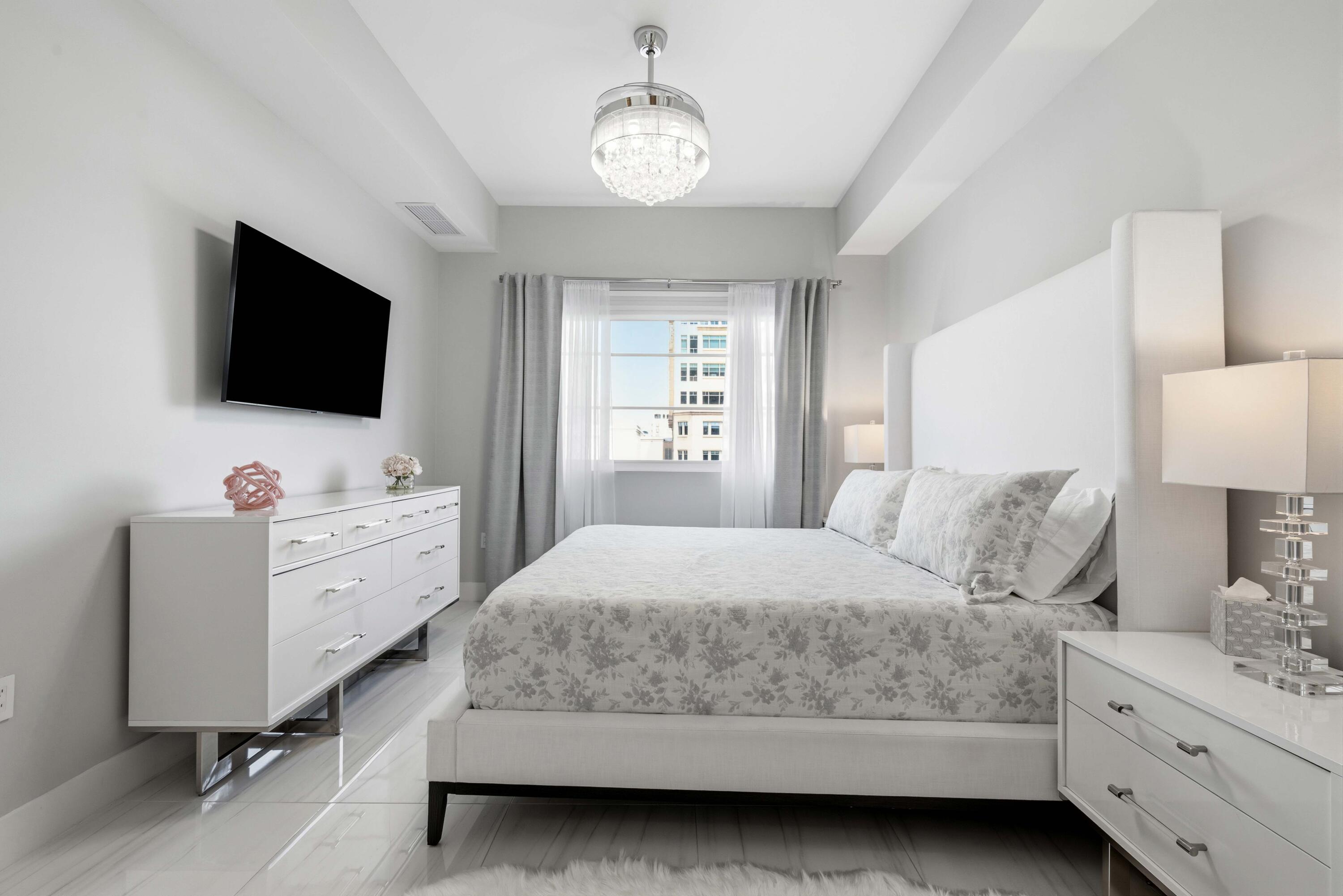 155 East Boca Raton Road, Unit 313 Boca Raton, FL 33432 - Photo 40 of 72 a bedroom with a bed and a flat screen tv