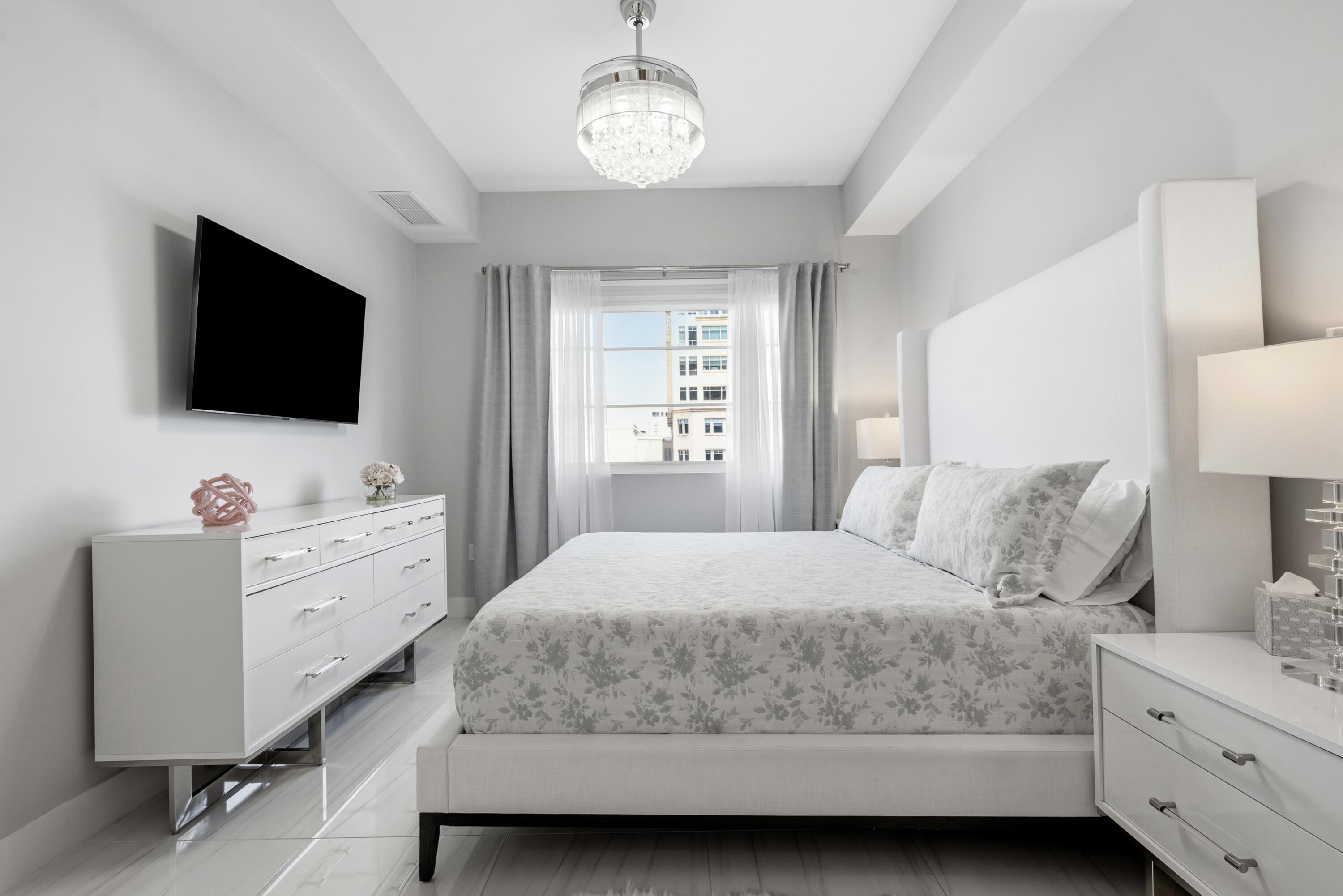 155 East Boca Raton Road, Unit 313 Boca Raton, FL 33432 - Photo 41 of 72 a bedroom with a bed and a flat screen tv