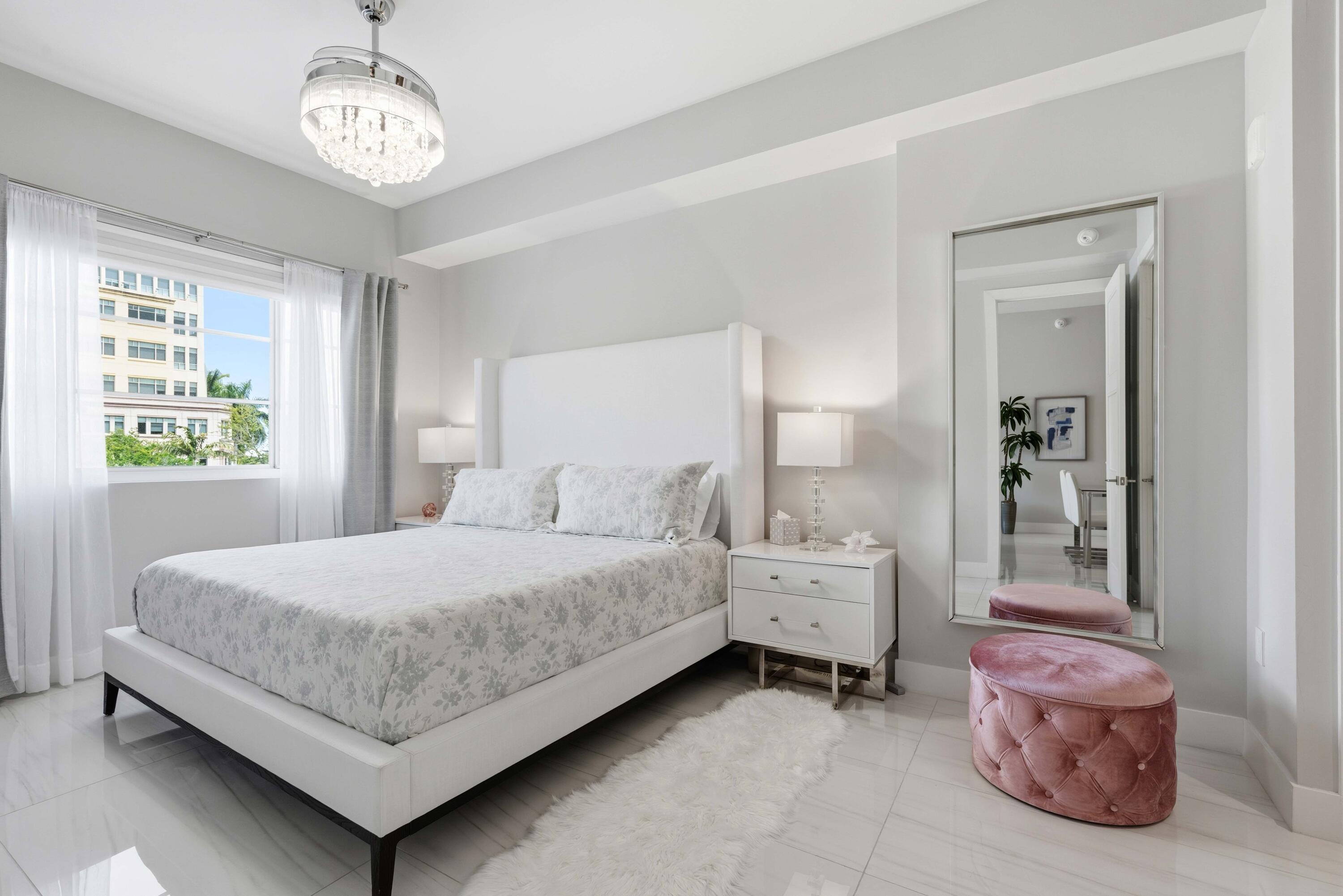 155 East Boca Raton Road, Unit 313 Boca Raton, FL 33432 - Photo 42 of 72 a bedroom with a bed chandelier and a window