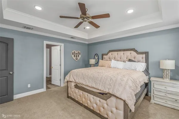 a bedroom with a bed and a ceiling fan