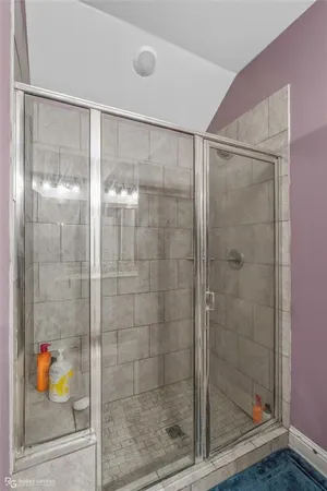 a bathroom with a glass shower door