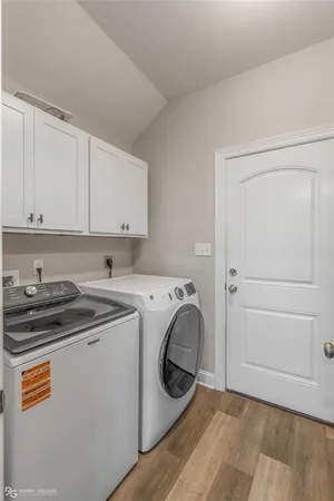 a utility room with sink dryer and washer