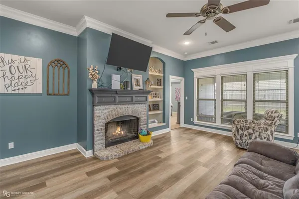 a living room with furniture and a fireplace