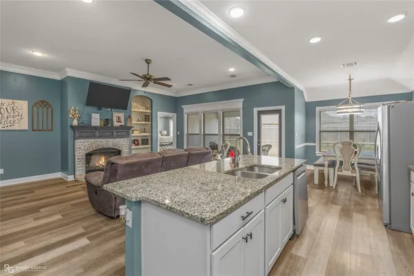 a open kitchen with stainless steel appliances granite countertop a stove and refrigerator