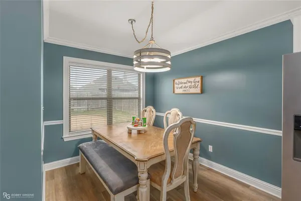 a dining room with a table and chairs
