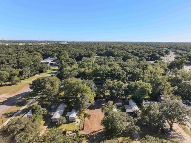 an aerial view of house with yard and mountain view in back