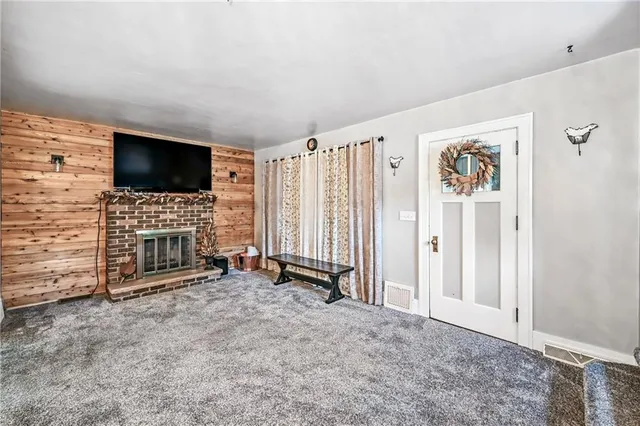 a living room with fireplace furniture and a flat screen tv