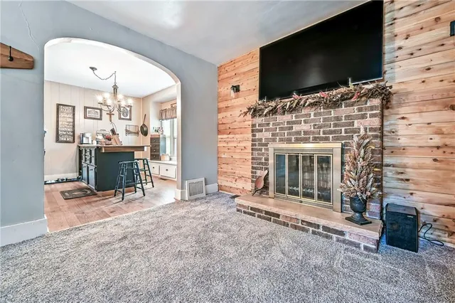 a living room with fireplace and flat screen tv