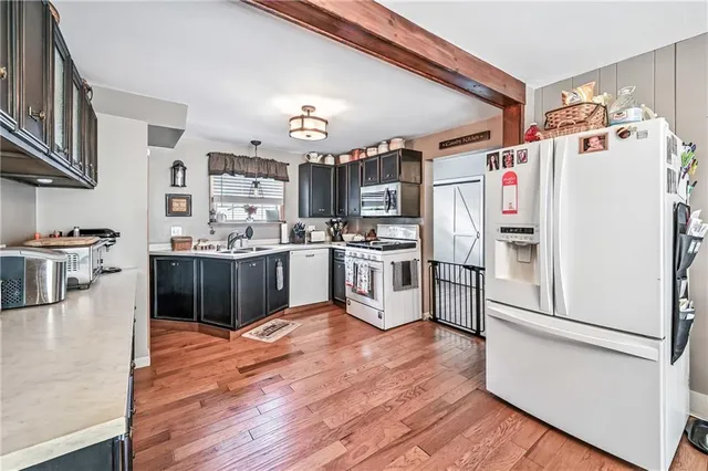 a kitchen with stainless steel appliances a refrigerator and a stove top oven