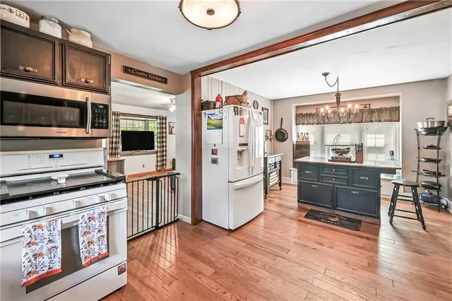 a kitchen with stainless steel appliances a stove top oven and a refrigerator