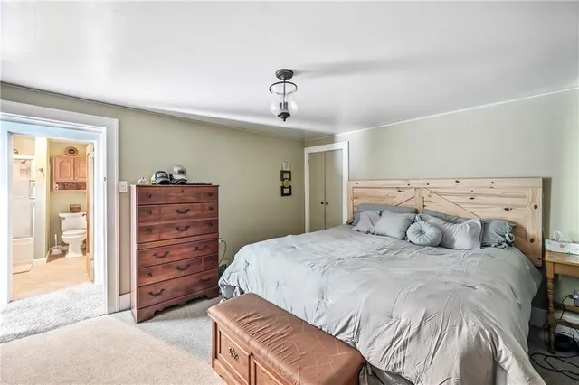 a bedroom with a bed dresser and a window