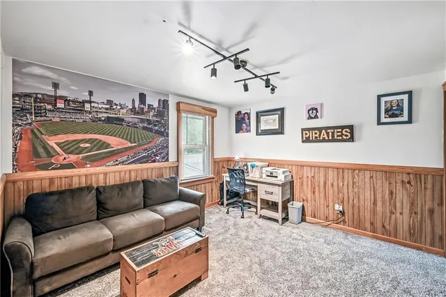 a living room with furniture a ceiling fan and a rug