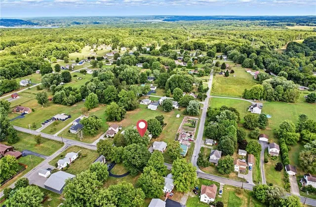 an aerial view of a houses with a yard