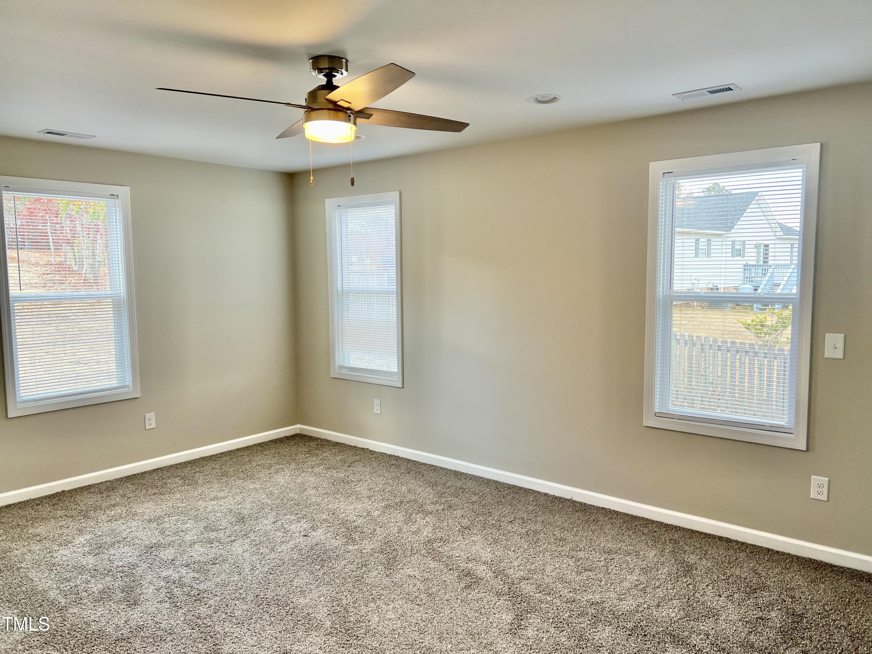 45 Summit Court Cameron, NC 28326 - Photo 15 of 19 an empty room with a window and a fan