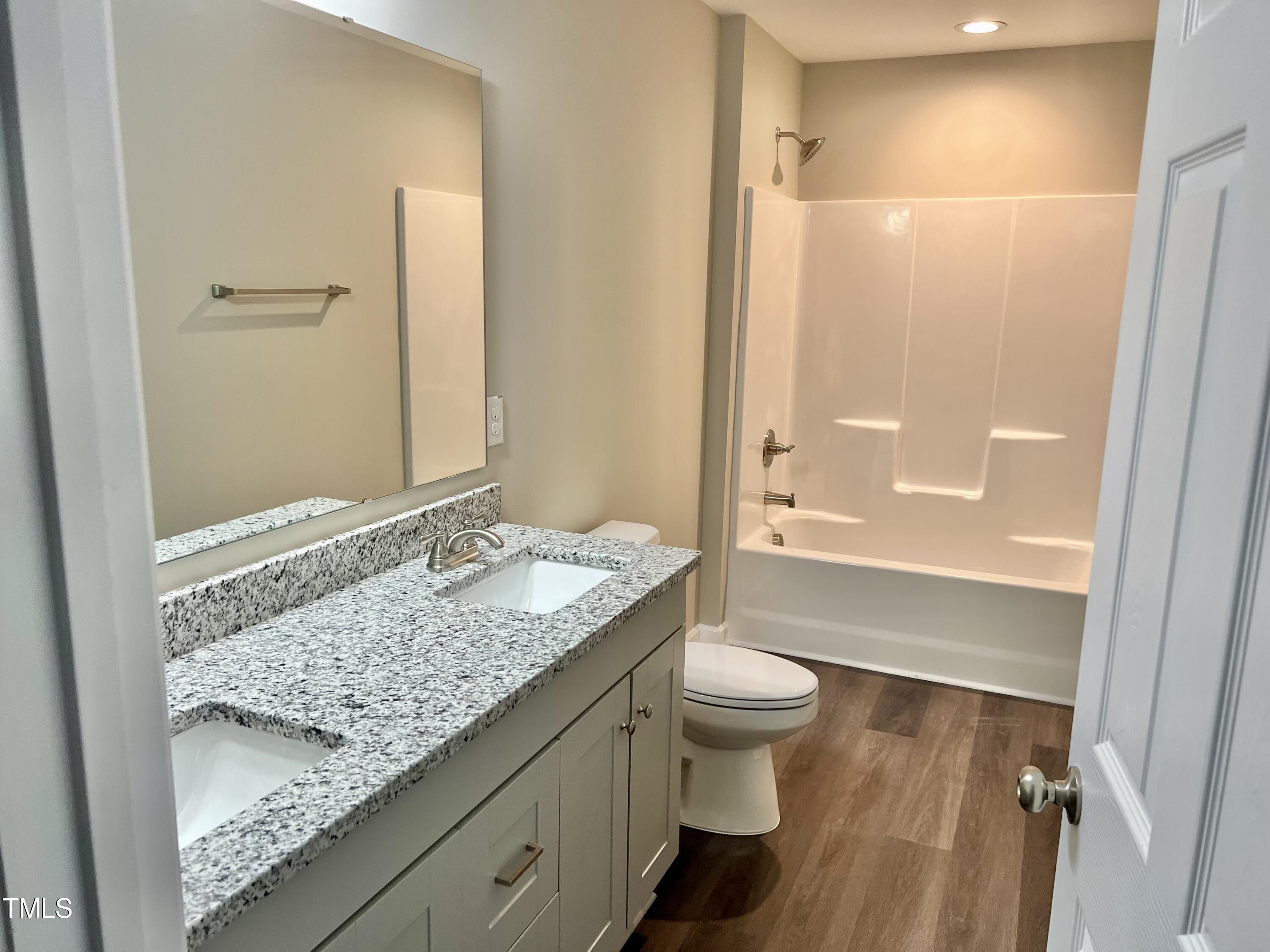 45 Summit Court Cameron, NC 28326 - Photo 16 of 19 a bathroom with a granite countertop sink toilet and shower