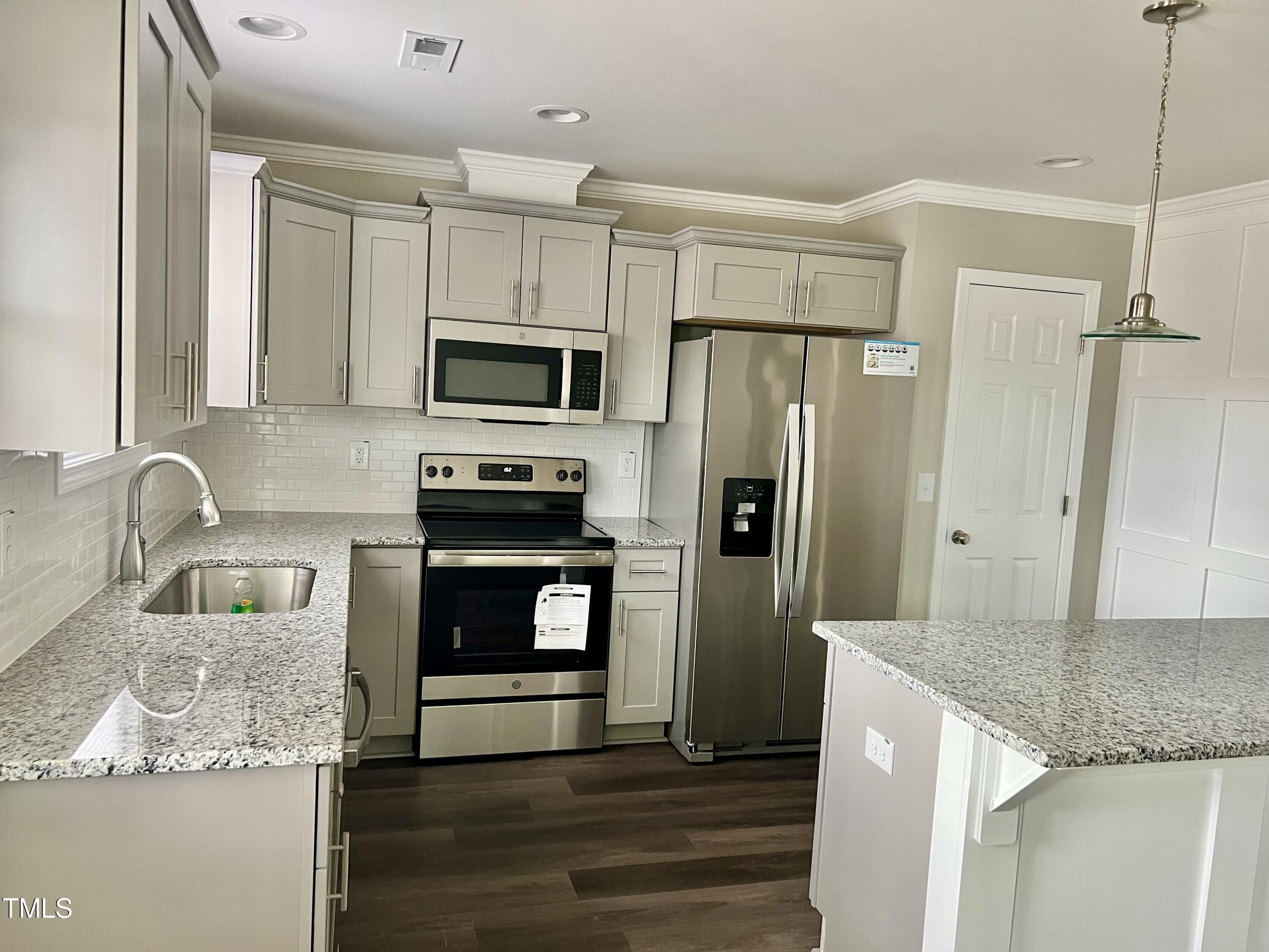 45 Summit Court Cameron, NC 28326 - Photo 4 of 19 a kitchen with granite countertop a refrigerator stove and sink