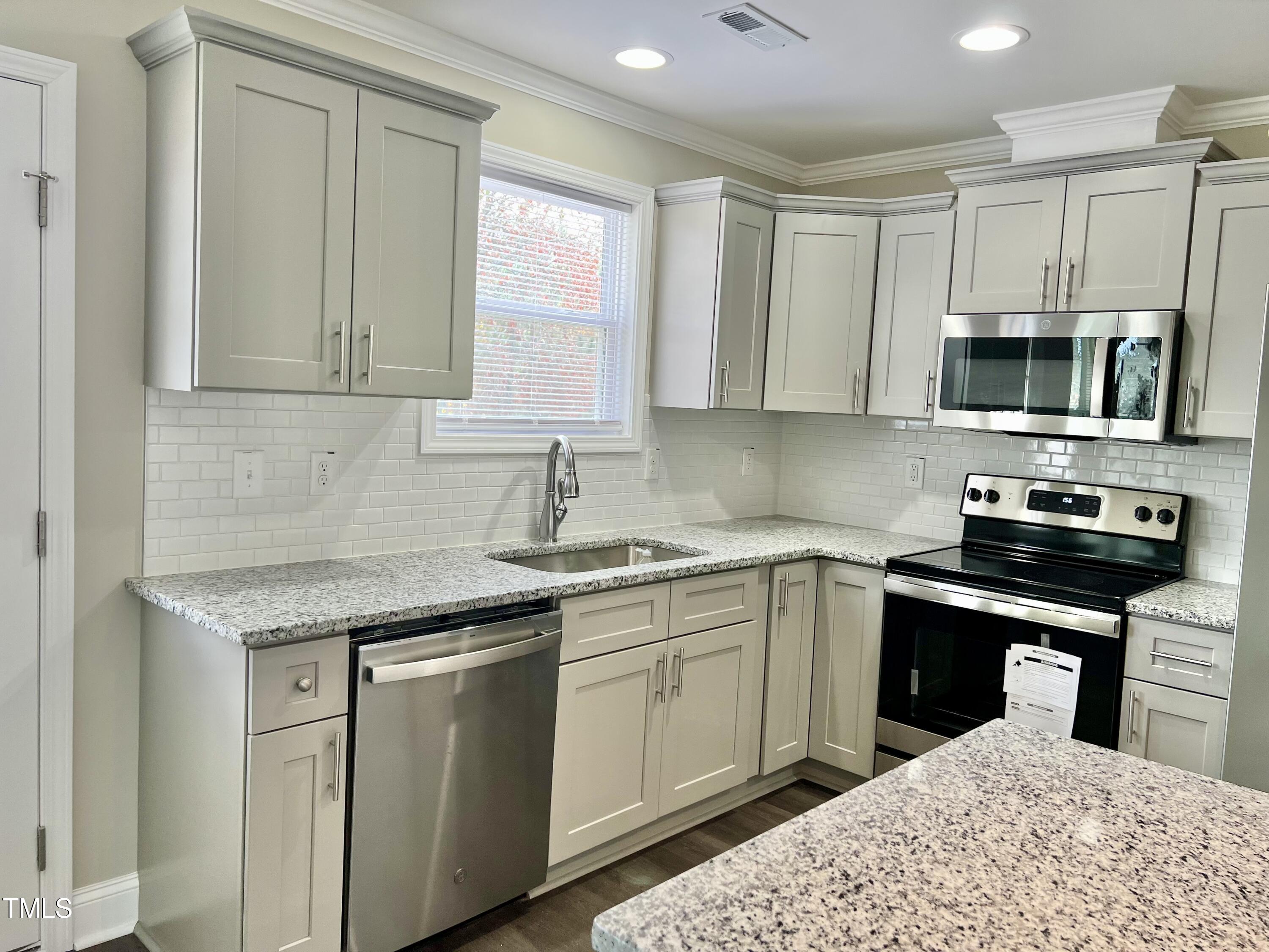45 Summit Court Cameron, NC 28326 - Photo 5 of 19 a kitchen with stainless steel appliances granite countertop a sink stove and microwave
