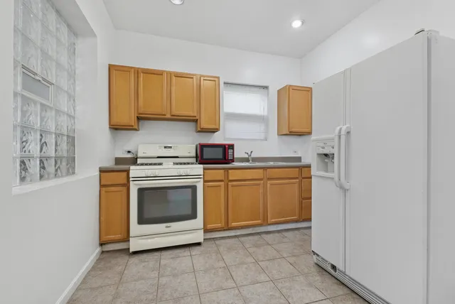 a kitchen with a stove top oven sink and cabinets
