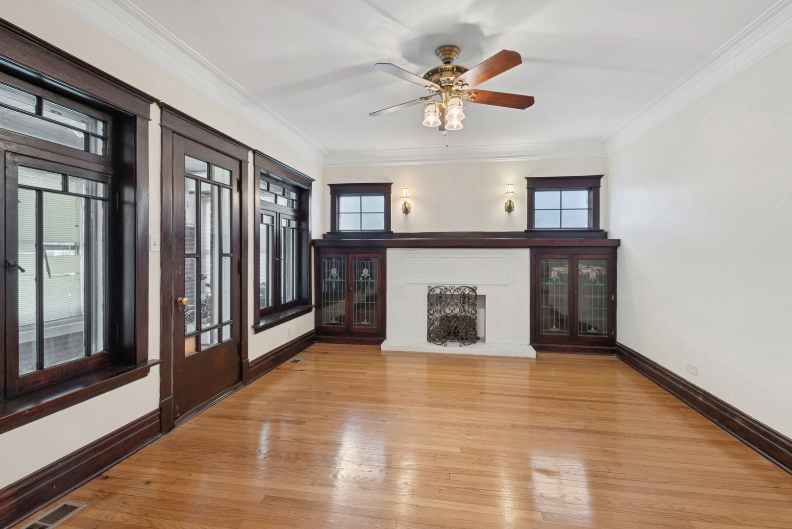 8040 South May Street Chicago, IL 60620 - Photo 5 of 23 a view of an empty room with chandelier fan and wooden floor