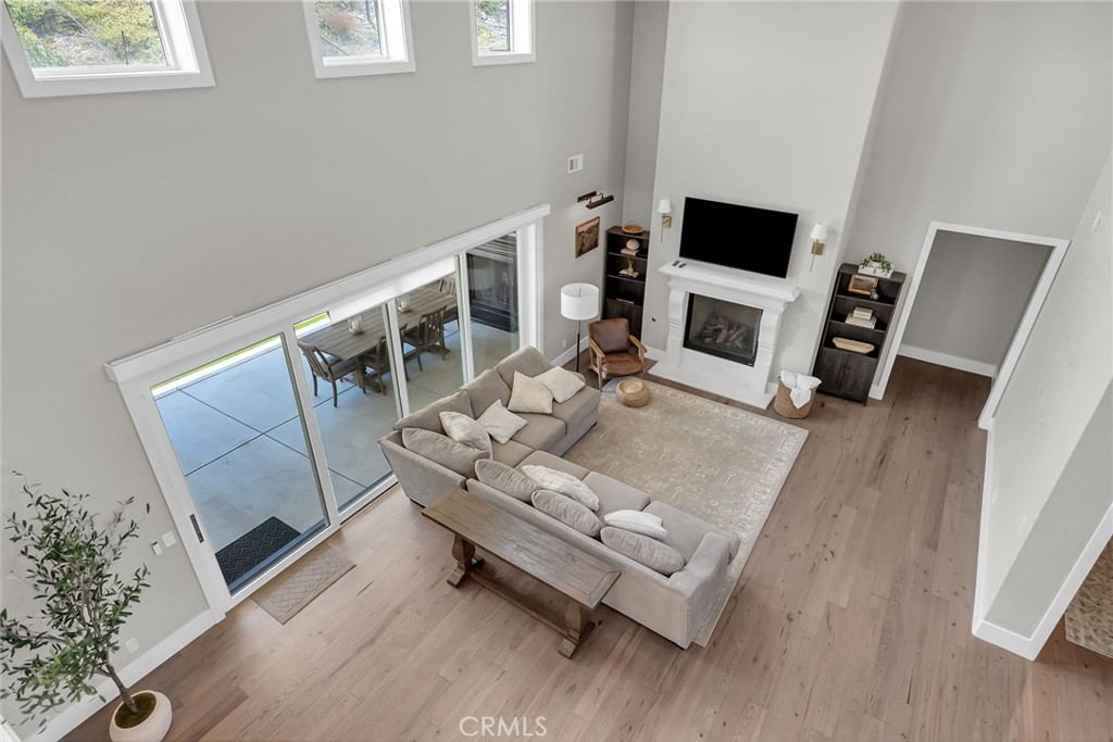 12237 Cortona Place Riverside, CA 92503 - Photo 12 of 17 a living room with furniture a fireplace and a flat screen tv