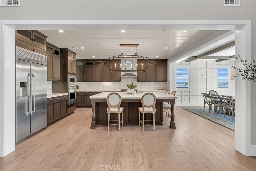12237 Cortona Place Riverside, CA 92503 - Photo 3 of 17 a kitchen with lots of counter top space and stainless steel appliances