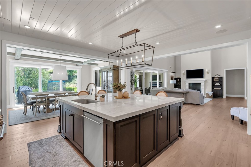 12237 Cortona Place Riverside, CA 92503 - Photo 6 of 17 a view of a kitchen counter top space with furniture a flat screen tv and outdoor seating