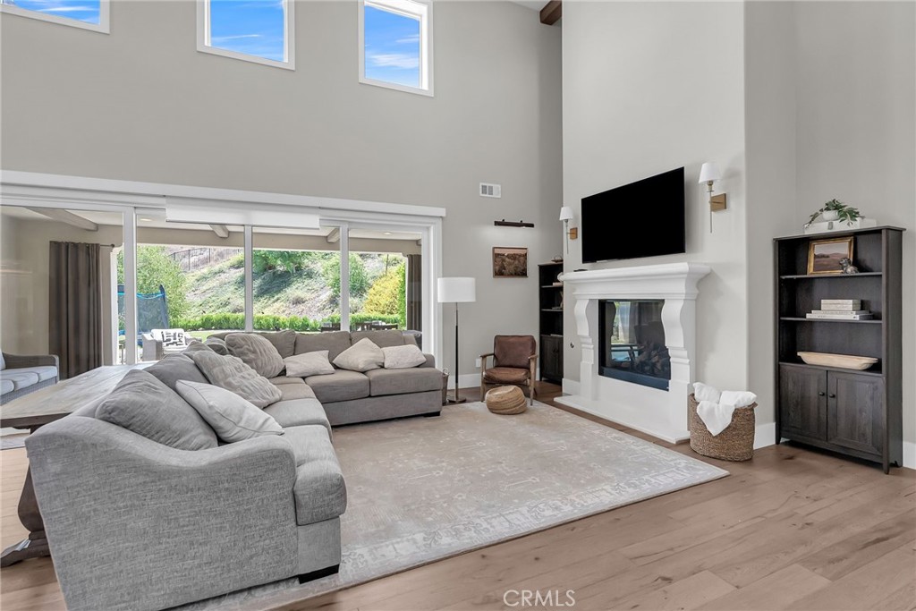 12237 Cortona Place Riverside, CA 92503 - Photo 8 of 17 a living room with furniture a flat screen tv and a fireplace