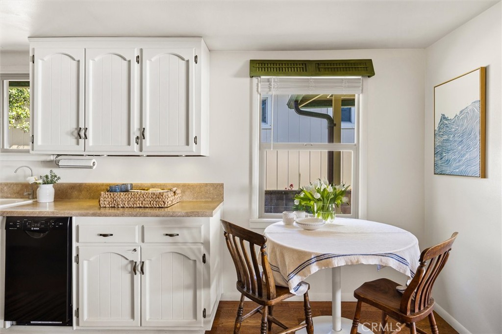 3448 Studio Drive Cayucos, CA 93430 - Photo 17 of 47 a kitchen with stainless steel appliances a white table chairs and a refrigerator