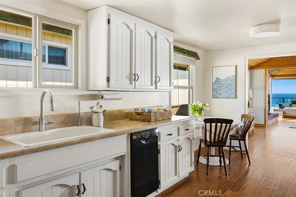 3448 Studio Drive Cayucos, CA 93430 - Photo 18 of 47 a kitchen with stainless steel appliances granite countertop a table chairs sink and cabinets