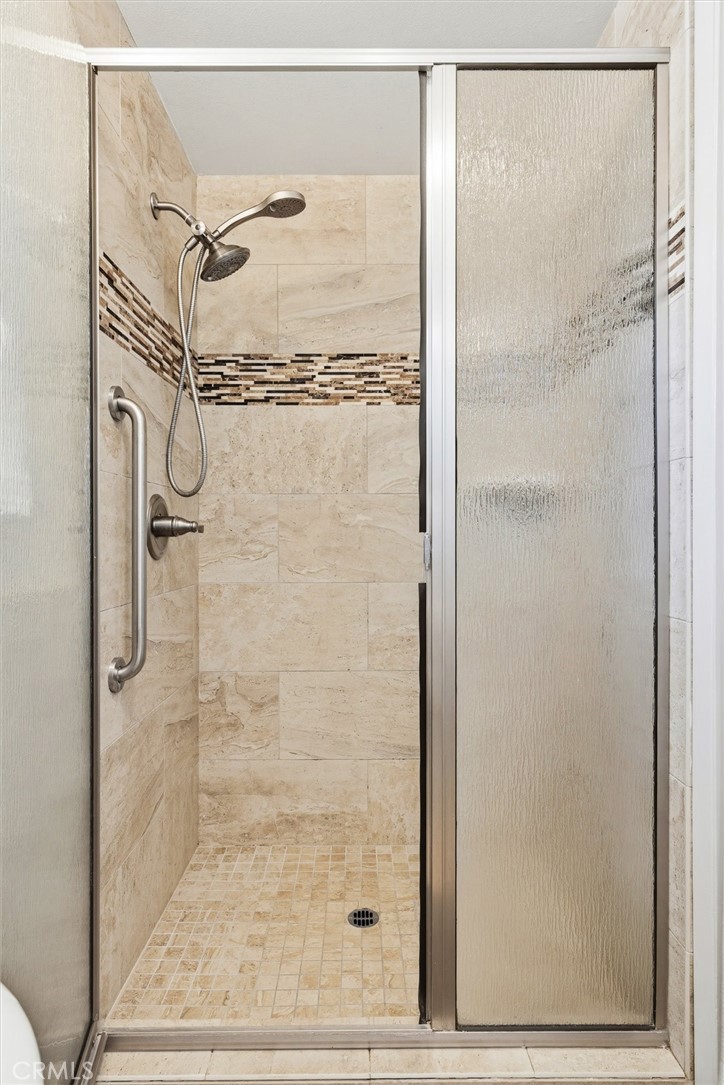 3448 Studio Drive Cayucos, CA 93430 - Photo 26 of 47 a bathroom with a glass shower door