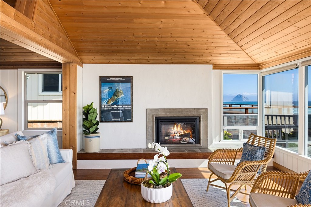 3448 Studio Drive Cayucos, CA 93430 - Photo 6 of 47 a living room with furniture potted plant and a fireplace