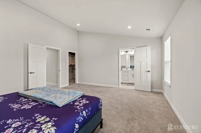 a bedroom with a bed and a shower