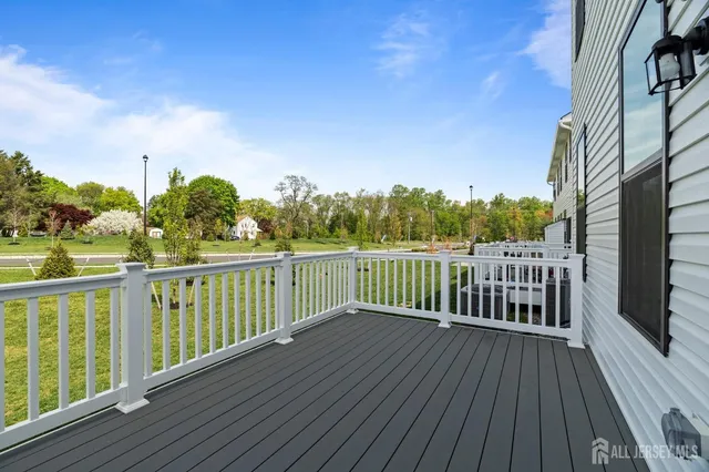 a view of a balcony with wooden floor and fence