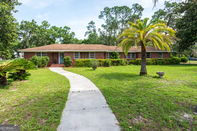 a view of a brick building next to a yard