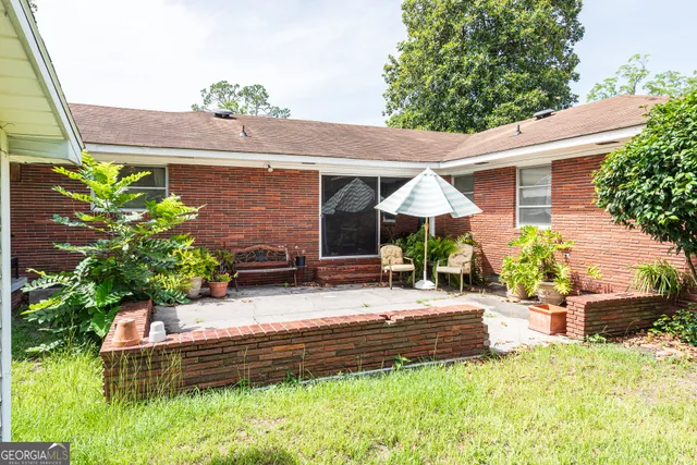 a view of a house with a big yard and potted plants