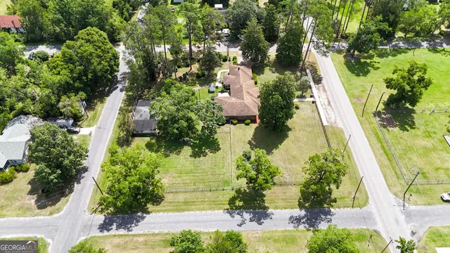 a view of a room that has a bed and a window with wooden floor