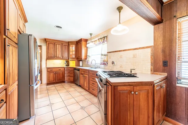 a view of hallway with stairs and wooden floor