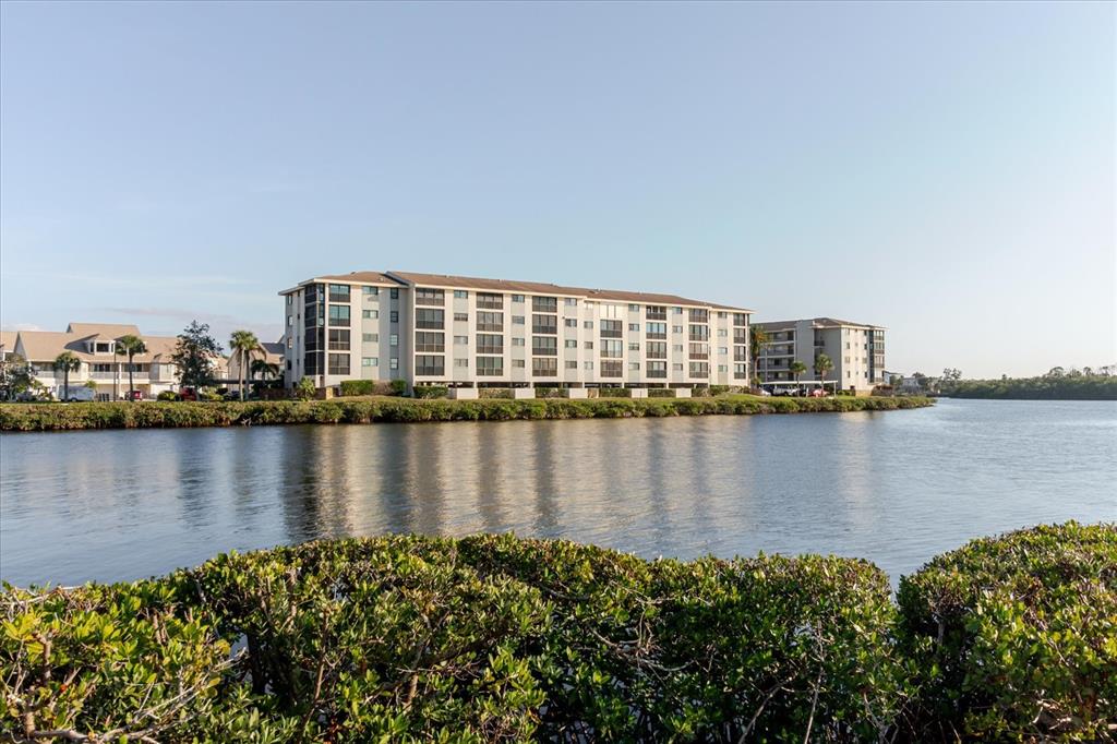 8211 Brent Street, Unit 828 Port Richey, FL 34668 - Photo 13 of 75 a view of a ocean with boats and trees in the background