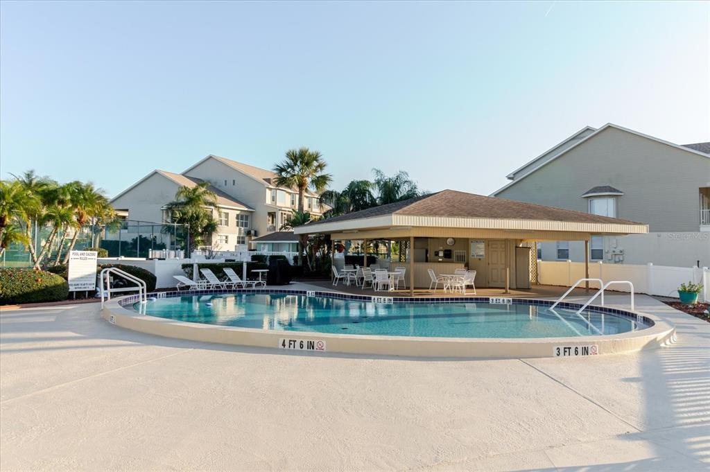 8211 Brent Street, Unit 828 Port Richey, FL 34668 - Photo 34 of 75 a view of a house with pool and chairs
