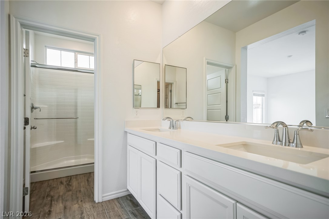 7348 North Decatur Boulevard, Unit 1 North Las Vegas, NV 89084 - Photo 7 of 17 Double vanity with sleek countertops offers ample space in this well-appointed bathroom.