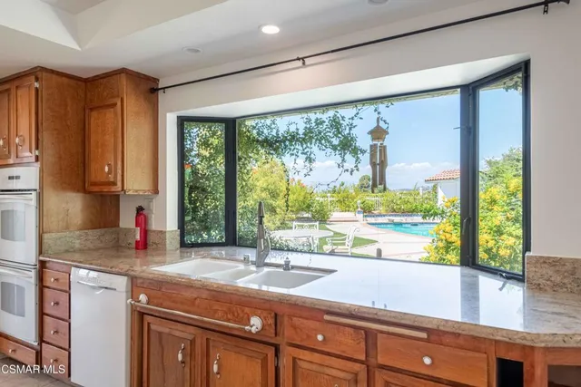 a kitchen with granite countertop a sink and a window