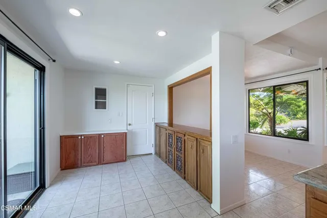 a view of a hallway with wooden shelves